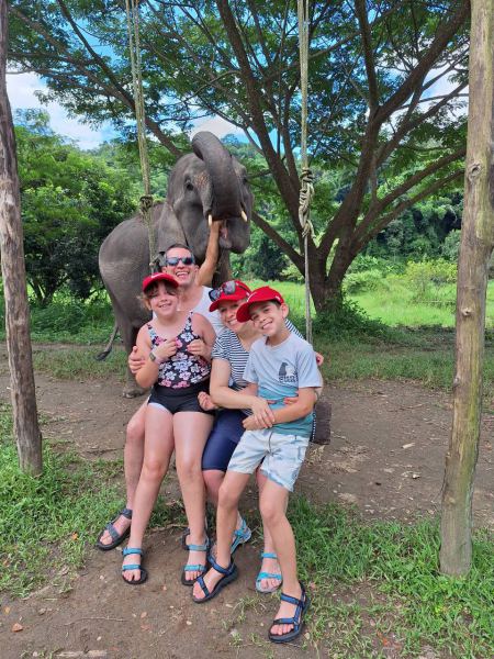 Children with an elephant reaching over the fence - lifeonwheel.com