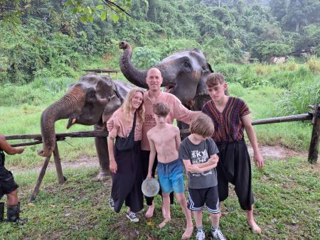 An elephant reaching up as the family gathers close - lifeonwheel.com