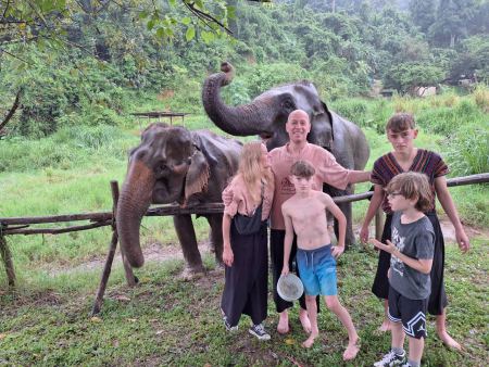Family group with the elephants under the misty trees - lifeonwheel.com