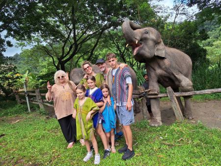 A family group with an elephant reaching for a treat - lifeonwheel.com