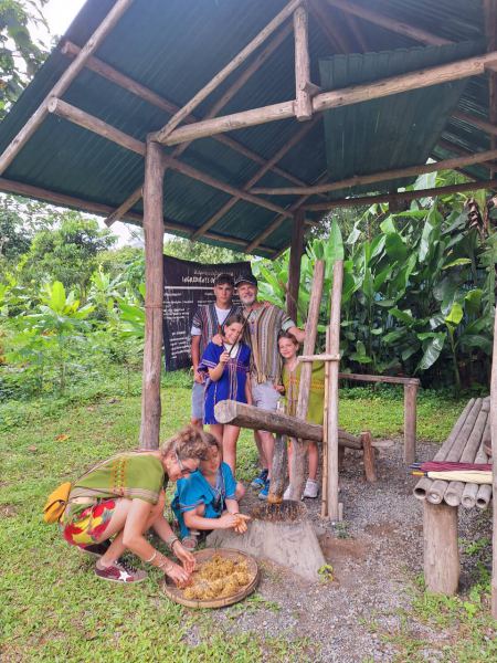 A family watching children pound elephant medicine at the herb station - lifeonwheel.com