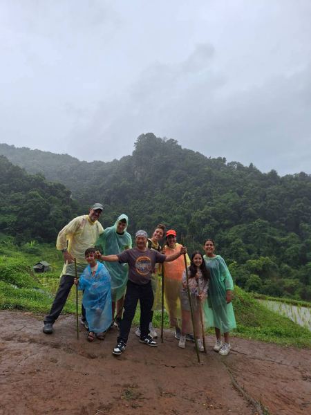 The whole trekking group gathered together with mountains behind them - lifeonwheel.com