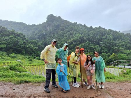 The group posing together with terraced rice fields in the misty valley - lifeonwheel.com