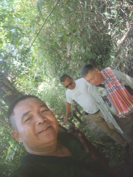 A guide taking a selfie leading two trekkers through the jungle path - lifeonwheel.com