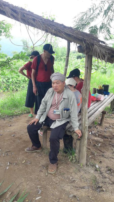 Trekkers resting at a bamboo rest shelter overlooking the valley - lifeonwheel.com