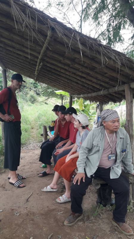 The group seated together at a thatched-roof rest stop with our guide - lifeonwheel.com