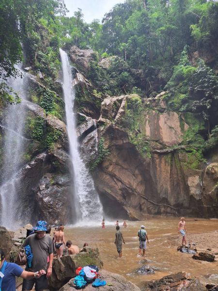 Guests swimming at the base of the tall falls - lifeonwheel.com