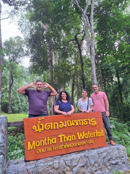 Guests posing at the Montha Than Waterfall sign - lifeonwheel.com